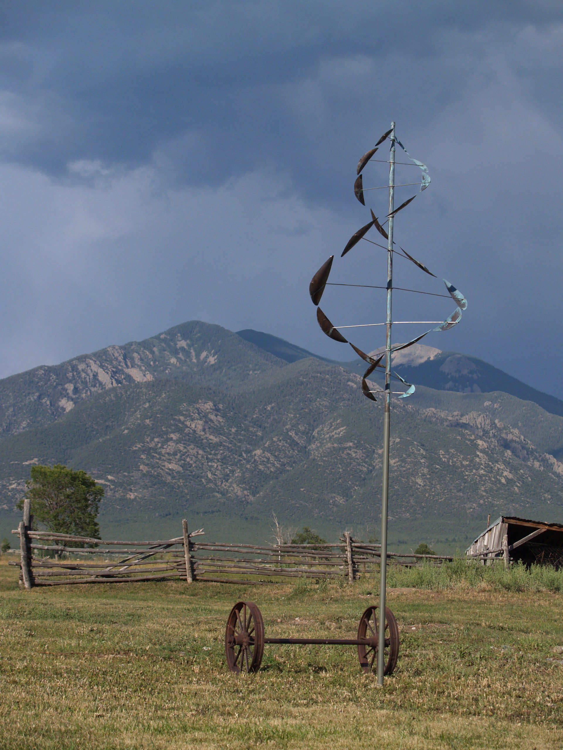 one wind dancer sculpture with mountain background