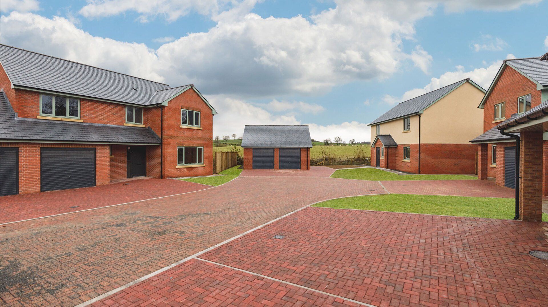 Street view of Phase 1 of Y Maes with fields in the background.