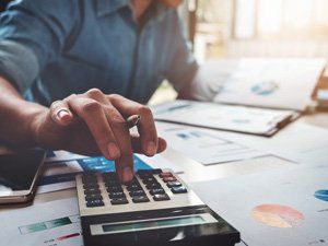 Man using a calculator, Financial
