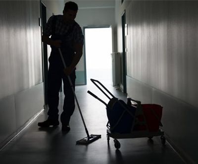 Avalanche Commercial Cleaning - Man With Broom Cleaning Office Corridor, USA Avalanche Commercial Cleaning - Man With Broom Cleaning Office Corridor, USA