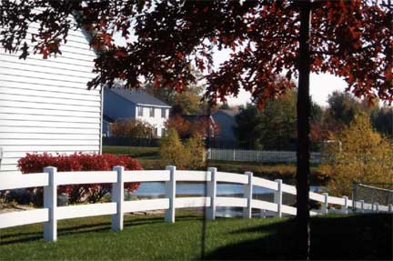 Vinyl Fence Contractor — White Vinyl Fence and a Tree in Grand Rapids, MI