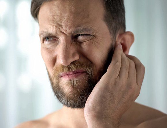 Man Holding His Ear — Rose Hill, KS — Rose Hill Chiropractic Man Holding His Ear — Rose Hill, KS — Rose Hill Chiropractic