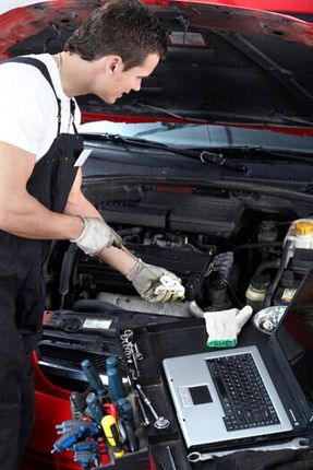 Mechanic checking oil Mechanic checking oil