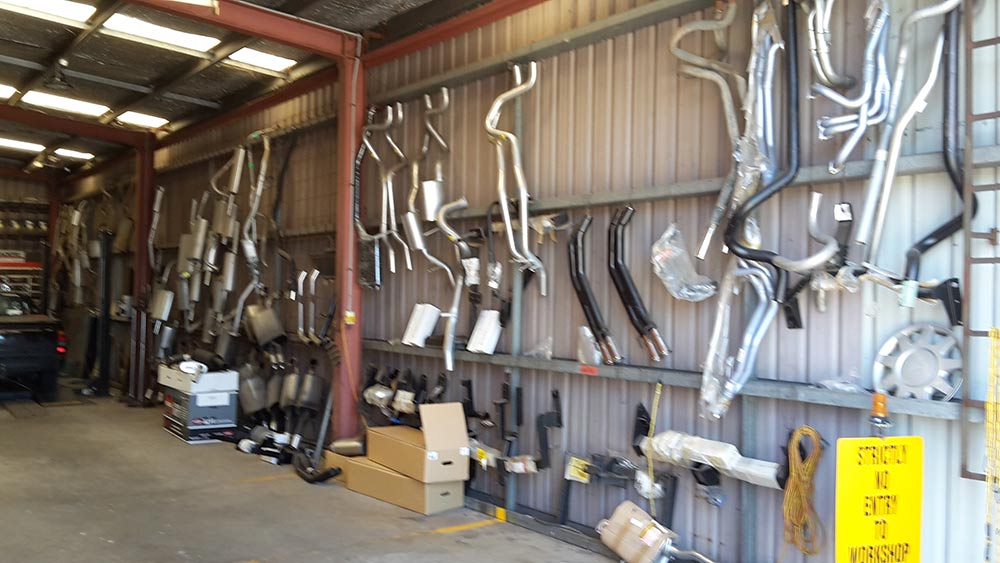 custom exhaust parts hanging on wall