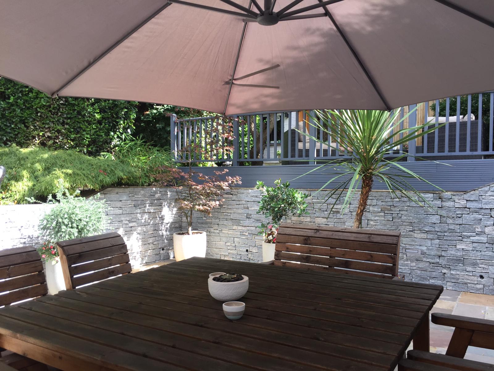 Patio z panelami grey granite Patio z murem z kamienia