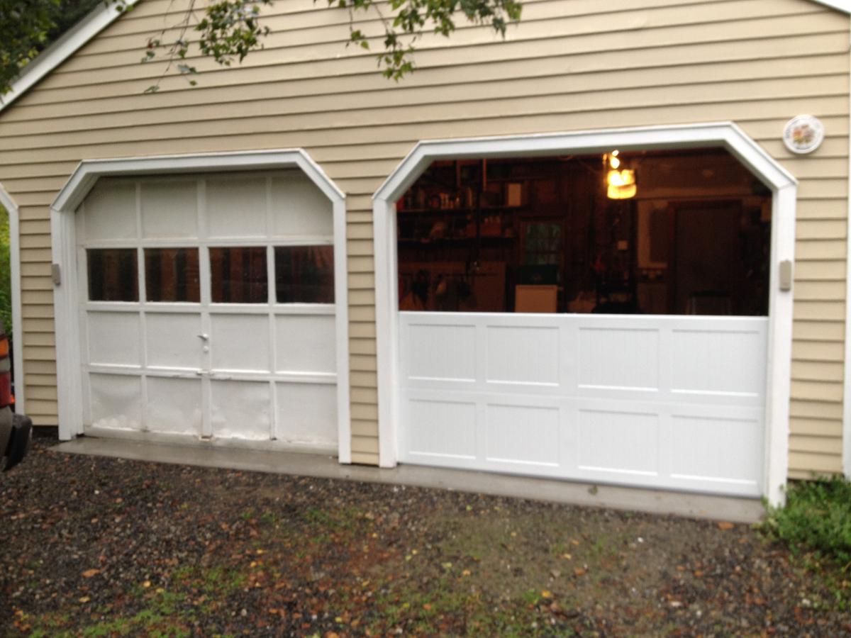 broken garage door with the top half open