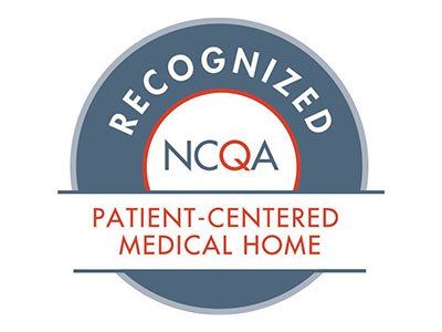 NCQA Patient-Centered Medical Home recognition seal, featuring a blue and white circular emblem with red text.