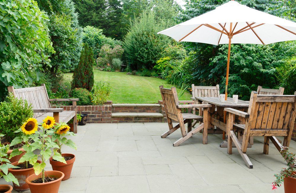 Patio with Garden Furniture and Parasol — Tampa, FL — J & M Lawn Service and More LLC