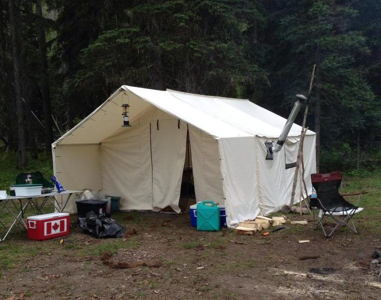 A tent with a cooler that says ice on it