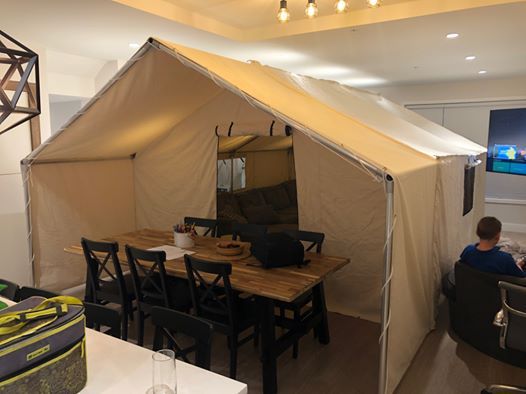 A tent with a table and chairs inside of it