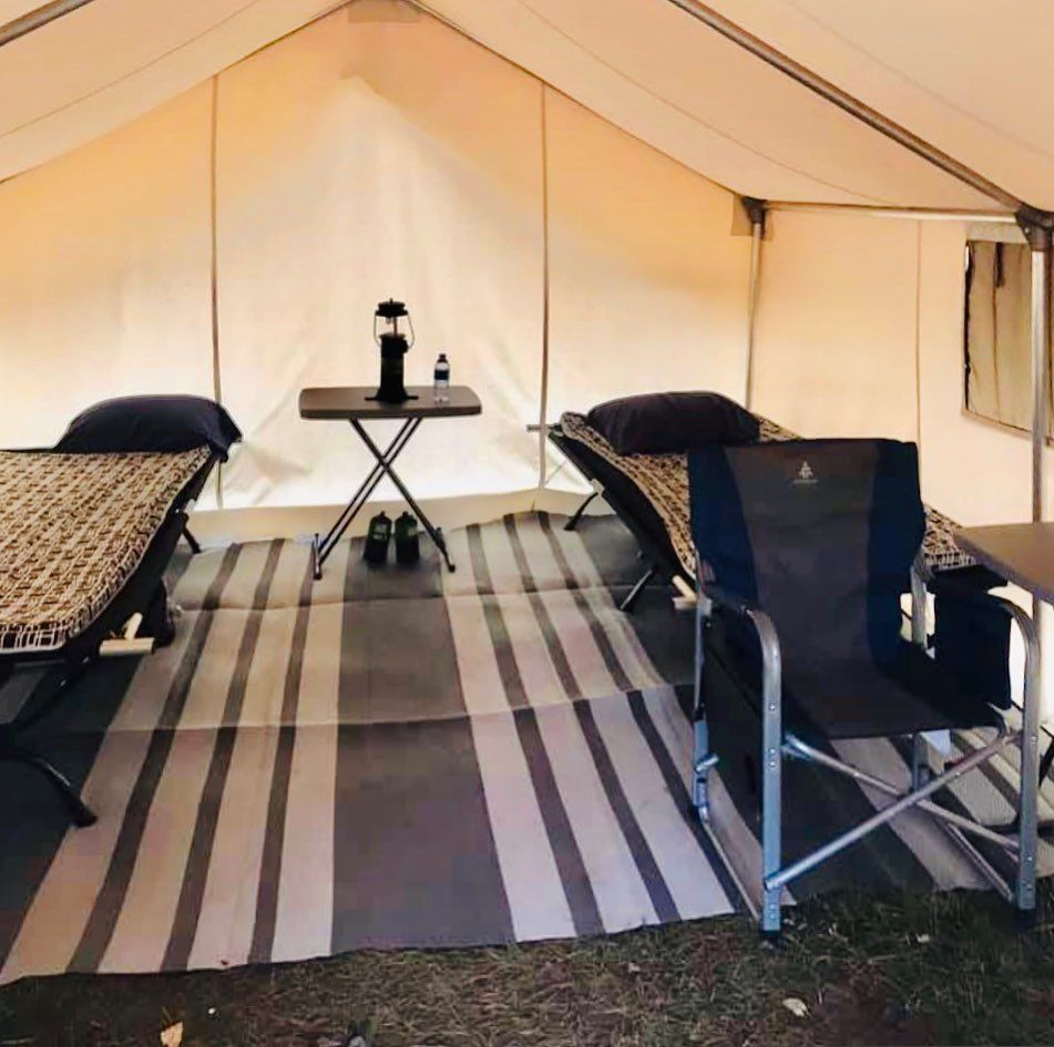 A tent with a table and chairs inside of it