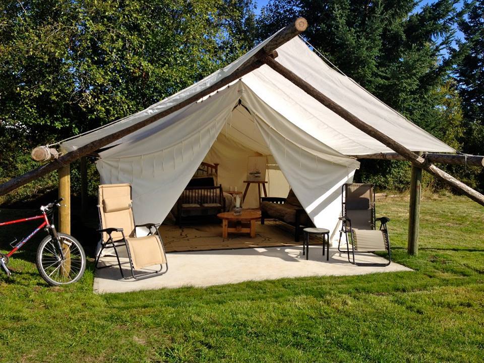 A tent with a bicycle parked in front of it.