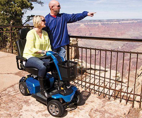 Mobility Equipment — Man and a Woman on an Electric Scooter in Lakewood, CO
