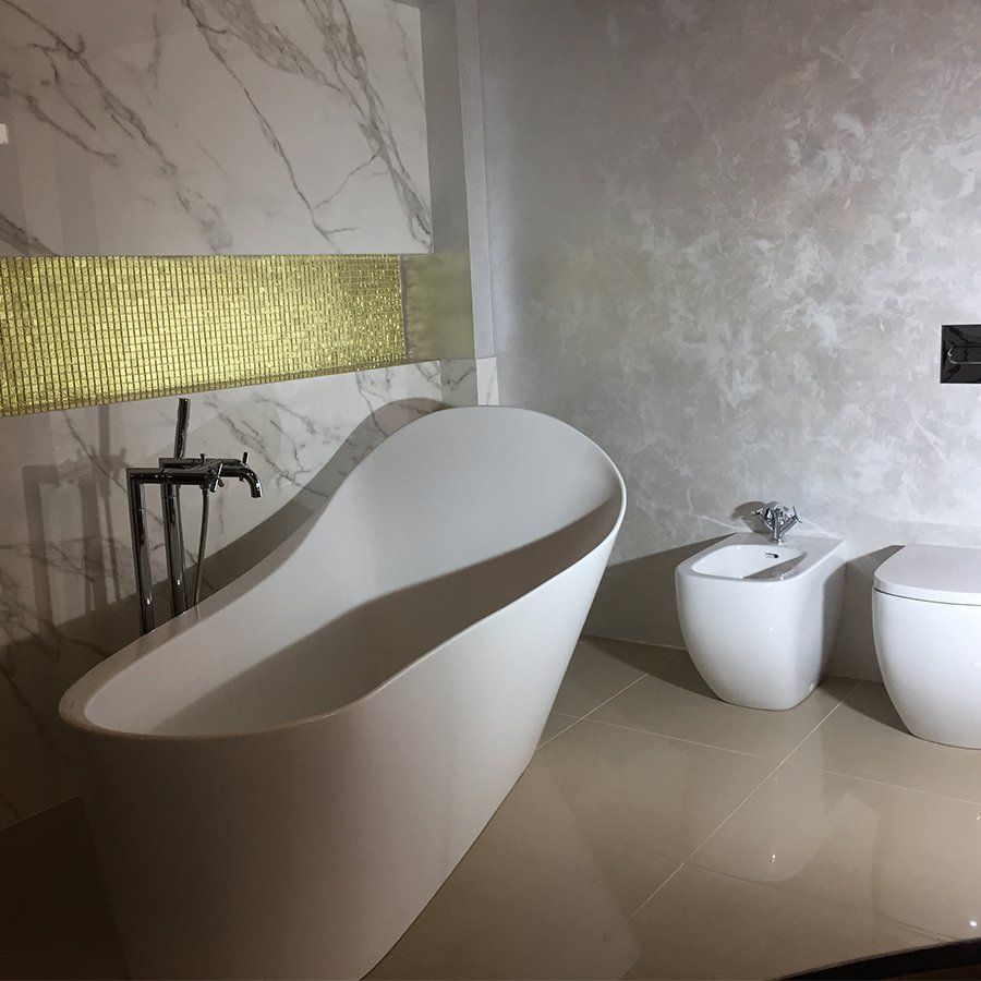 stylish bathroom with curved tub and toilet