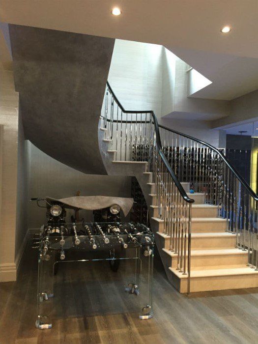venetian plastery light stairs in a grey hall