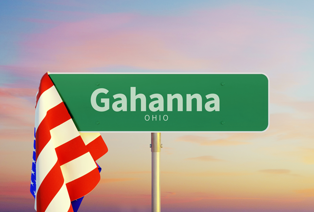 A green street sign for Gahanna Ohio with an American flag