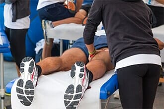 Athletes massage before sport event — Sports Physical Therapy in Old Bridge, NJ