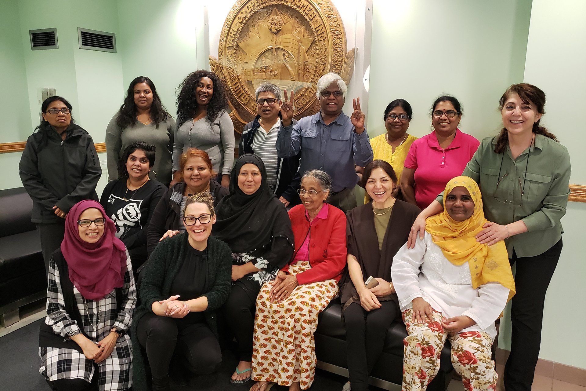 A group of women are posing for a picture in front of a seal.