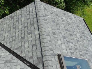 A roof with a skylight on top of it.