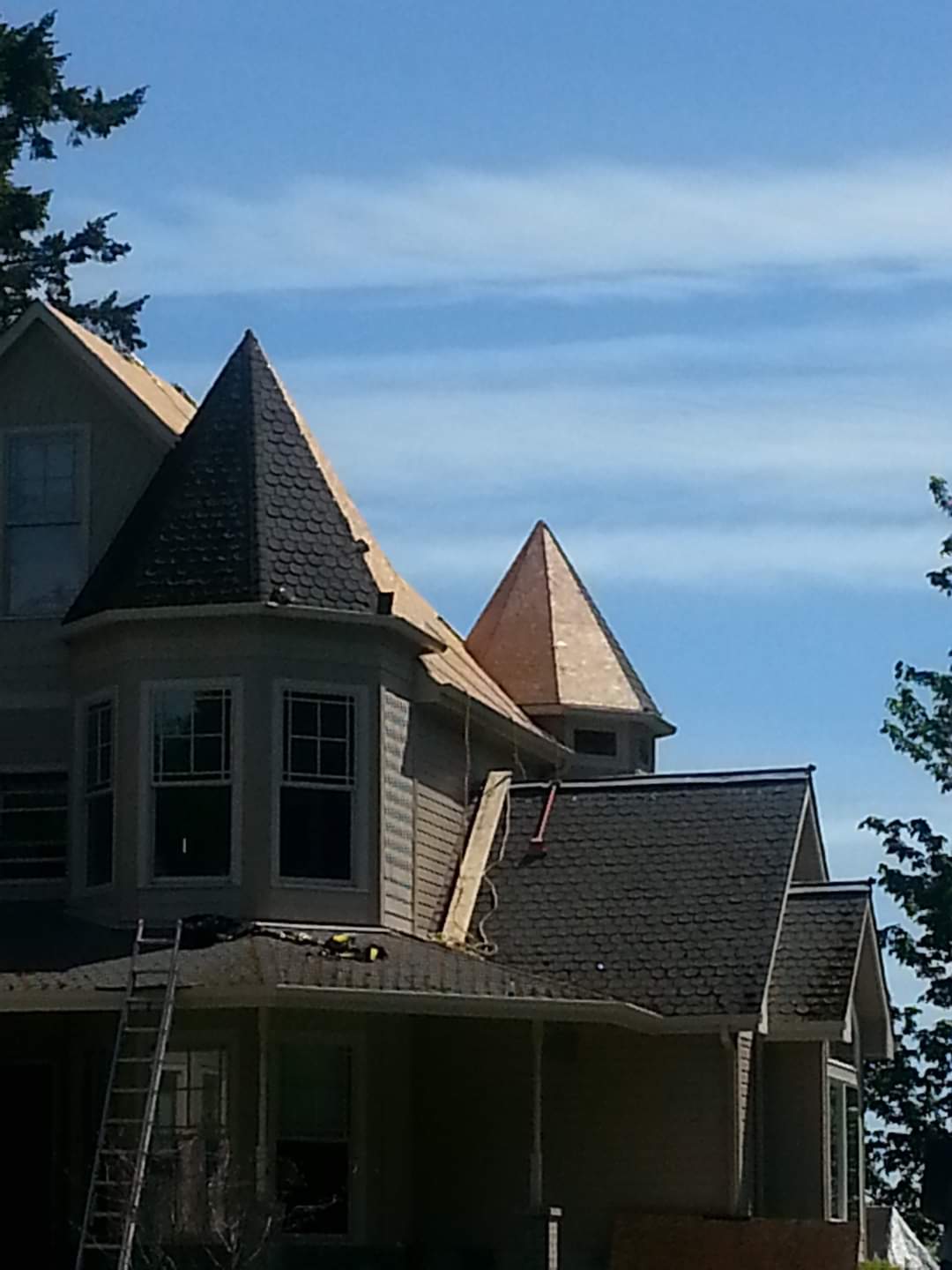 A house with a pyramid shaped roof is under construction