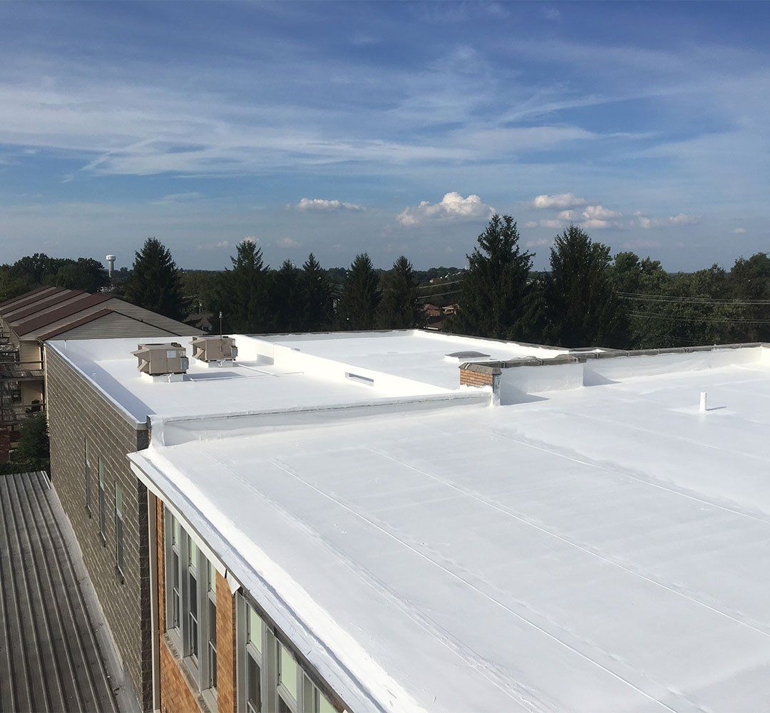 A building with a white roof and a blue sky in the background