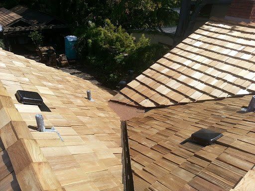 A wooden roof with a few trees in the background
