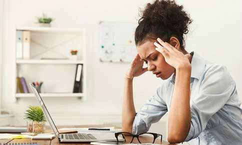 Woman Experiencing Headache at Work — Sunnyside, WA — Yakima Valley Chiropractic Center Woman Experiencing Headache at Work — Sunnyside, WA — Yakima Valley Chiropractic Center