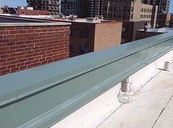 Finished metal coping with Wickright installed underneath on parapet in Uptown Chicago, now dry.