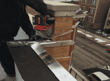 WickRight vented drip edge being installed on parapet Grand Boulevard, Chicago. Building is now dry.