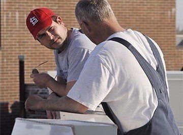 Bob Kelly and client discuss installing WickRight  on split face block building Lakeview, Chicago