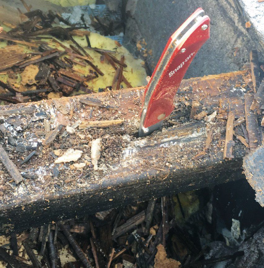 Rotting truss with red pocket knife