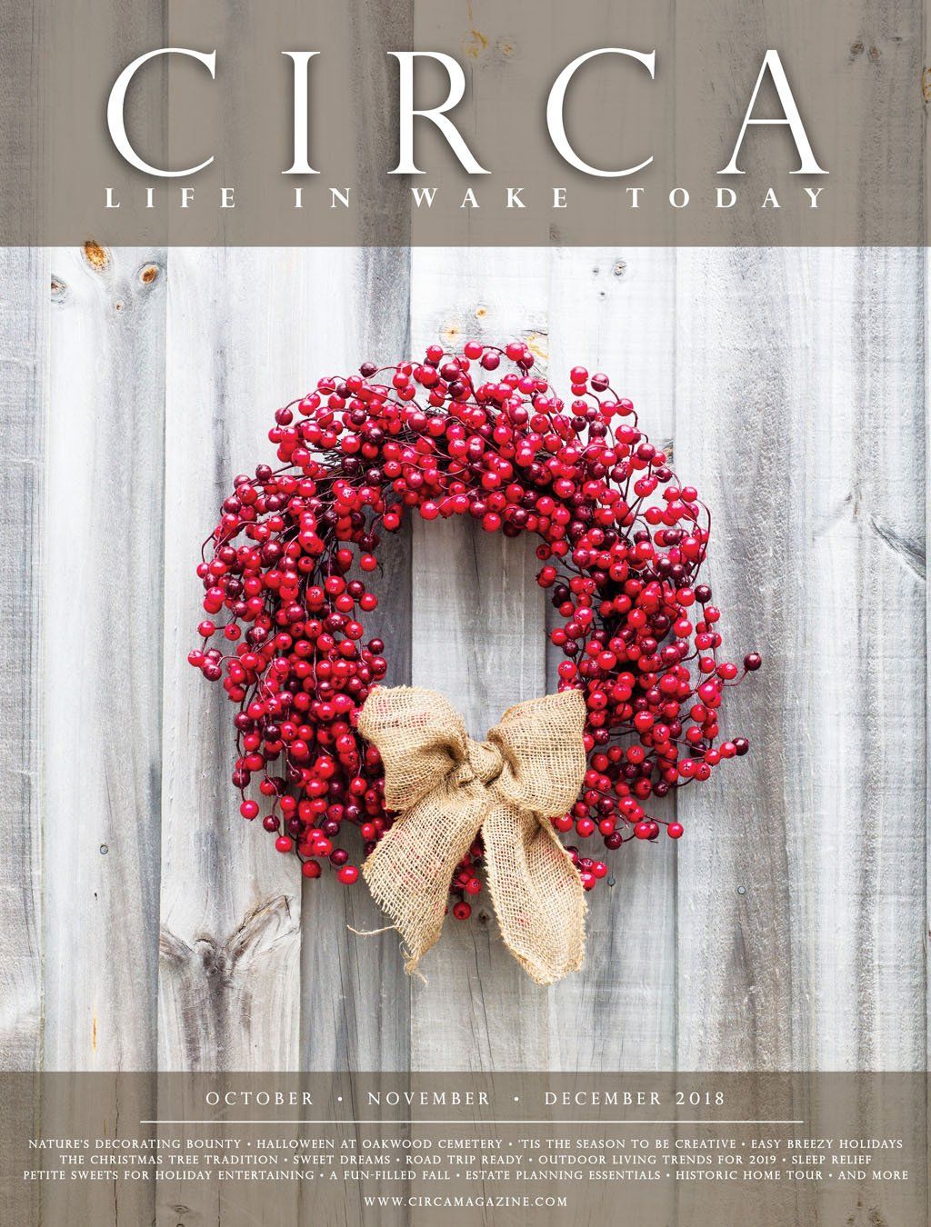 Magazine cover with a red berry wreath and burlap bow on a weathered wooden wall.
