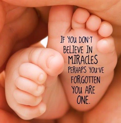 Baby feet held in hands, with text on the foot: