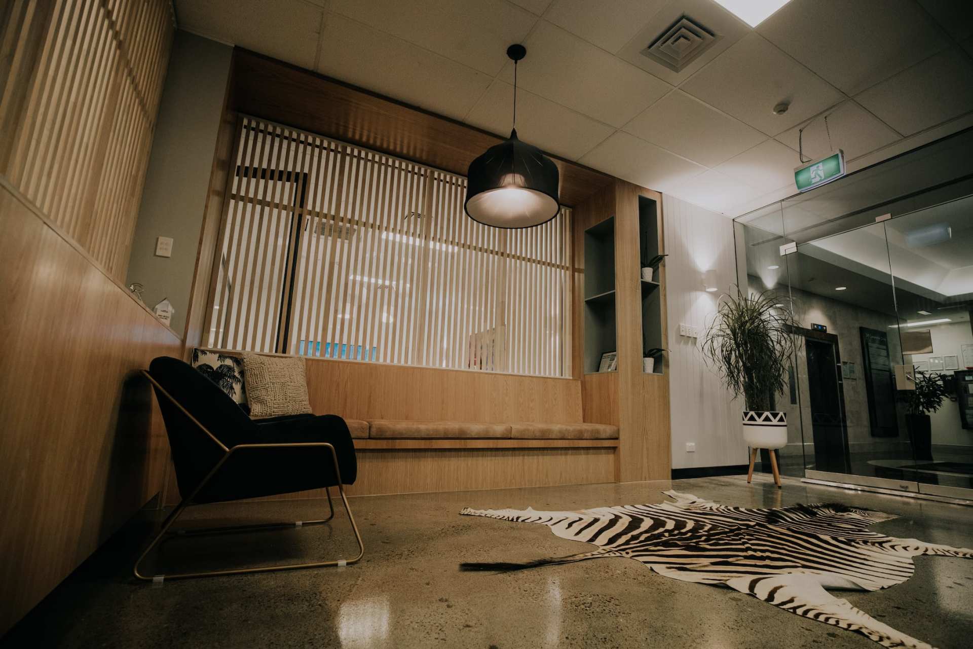 A room with a chair and a rug on the floor.