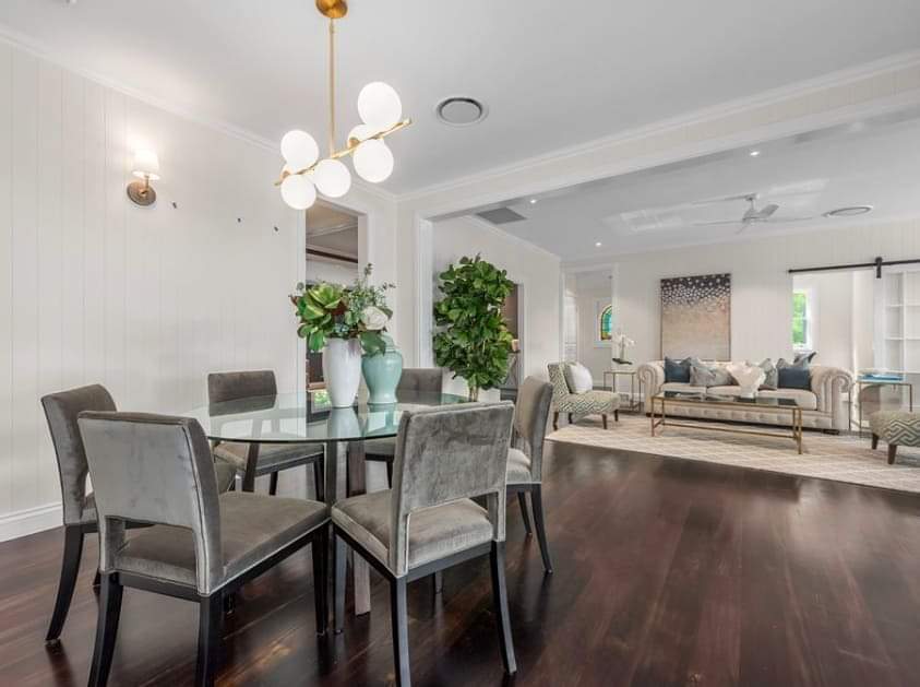 There is a dining room table and chairs in the middle of the room.