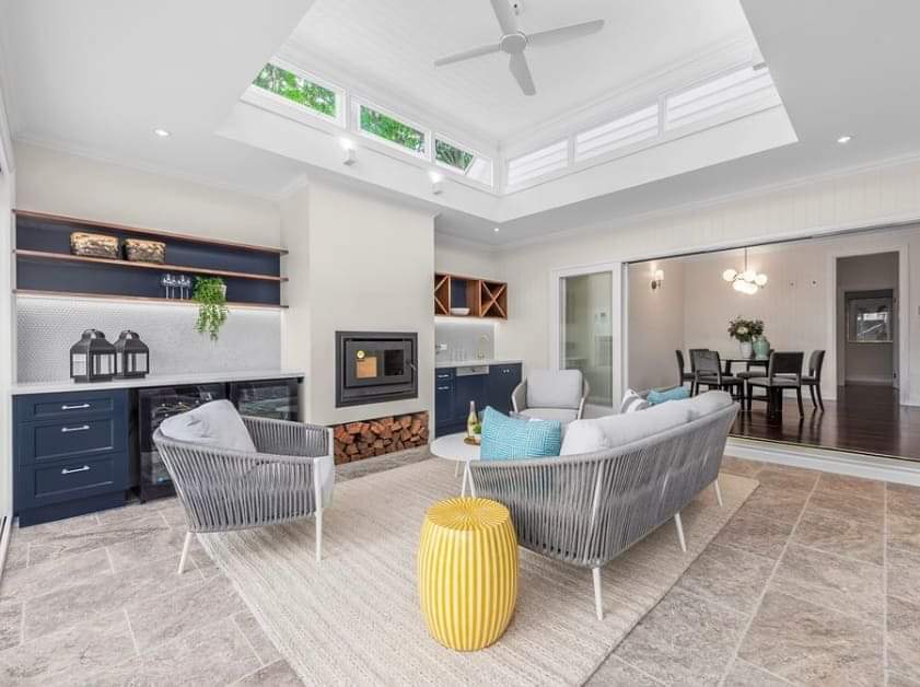 A living room with a couch , chairs , and a fireplace.