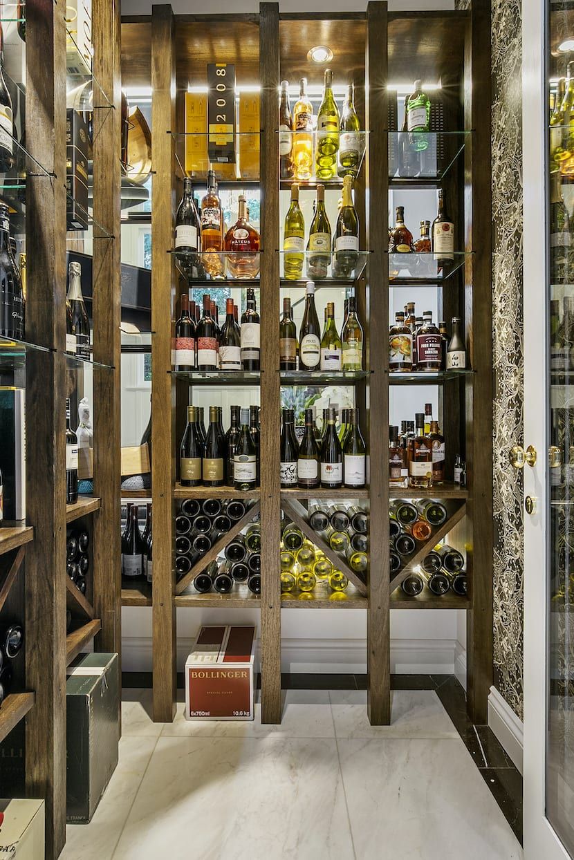 A wine cellar filled with lots of wine bottles on shelves.