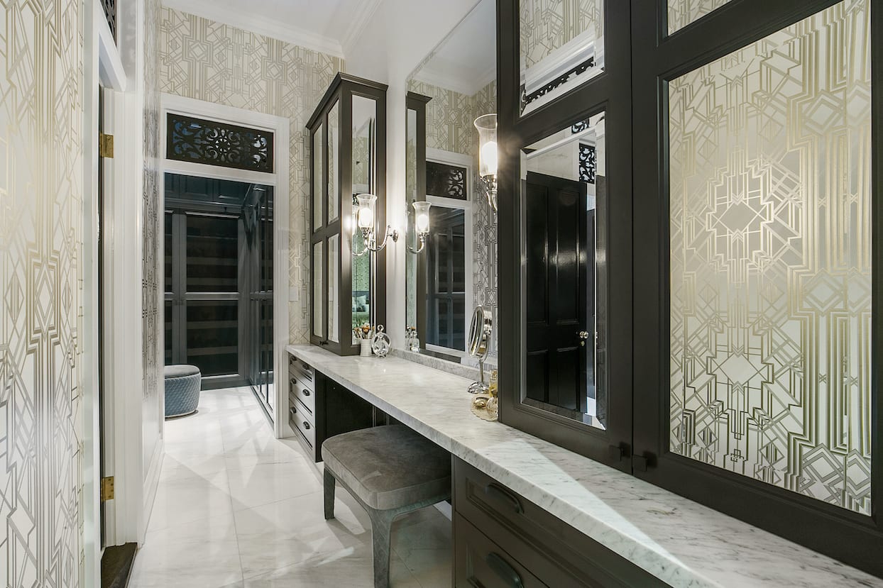 A bathroom with a long vanity and mirrors.