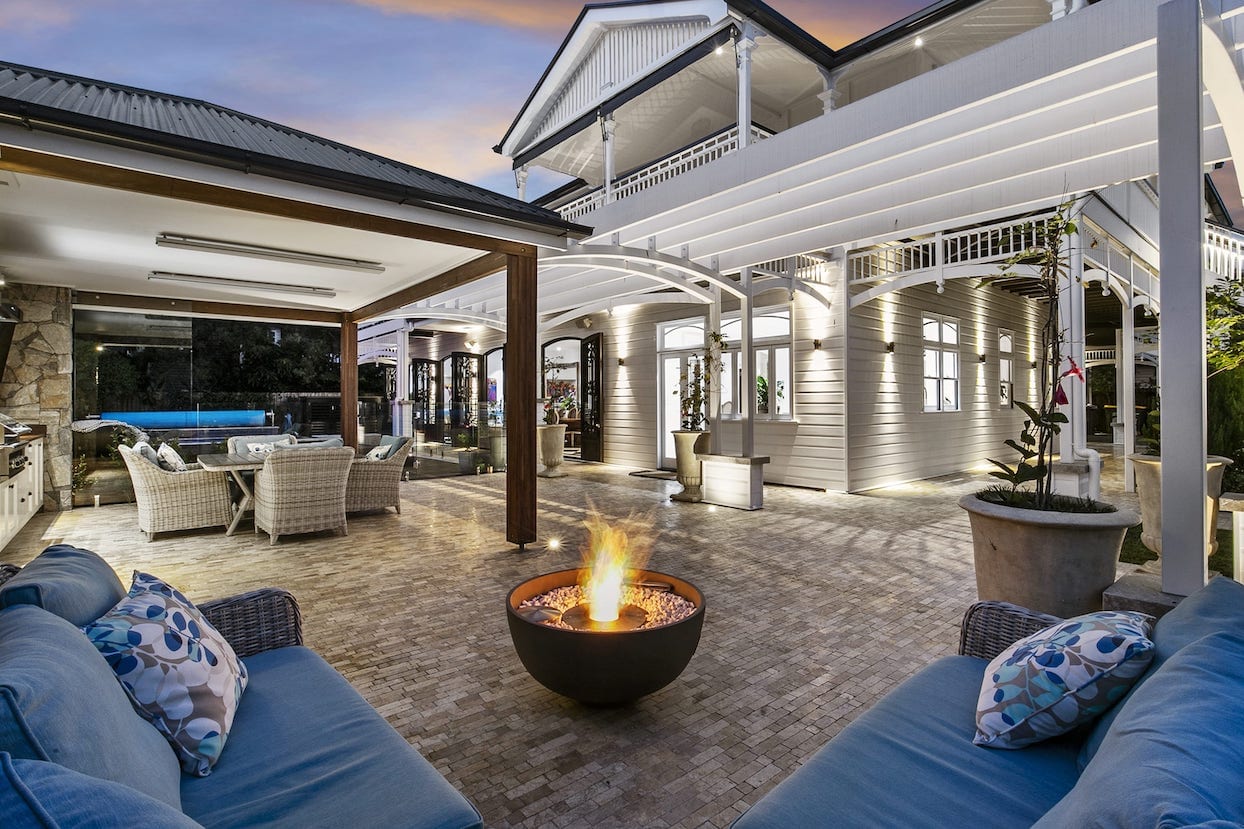 There is a fire pit in the middle of the patio.