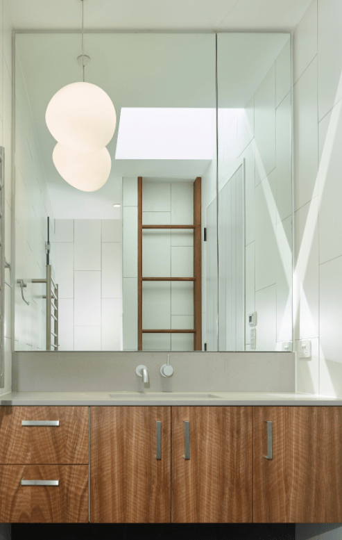 A bathroom with a sink and a large mirror