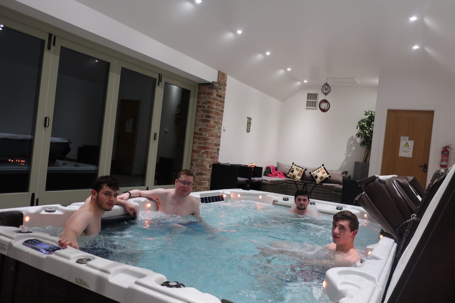 A group of men are swimming in a large hot tub
