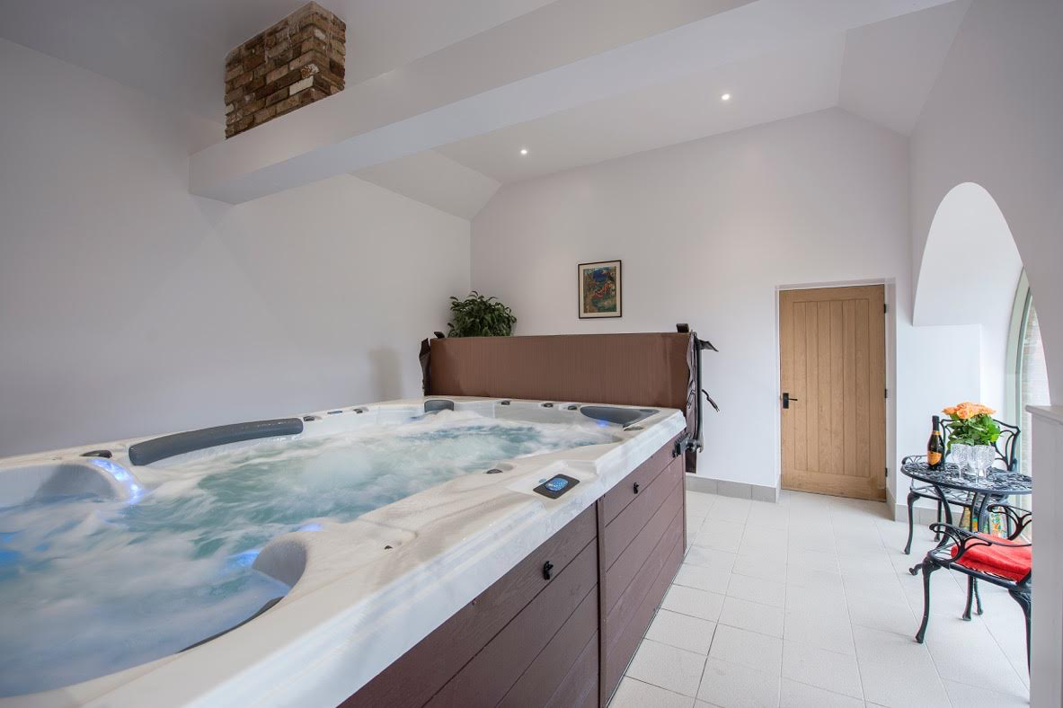 There is a large hot tub in the middle of the room.