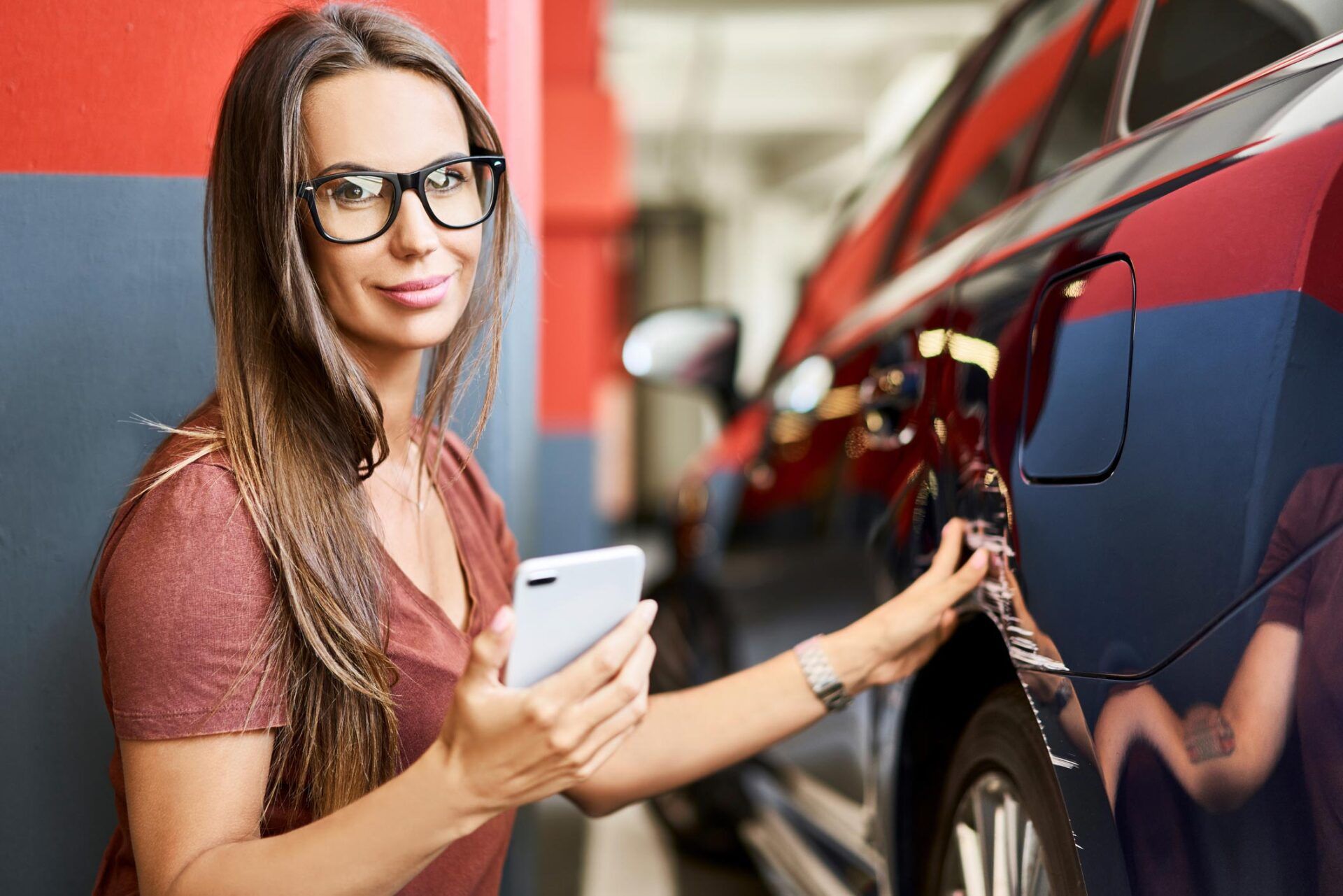 Woman Holding Phone Checking Car — Homestead, FL — South Dade Auto Tag Agency