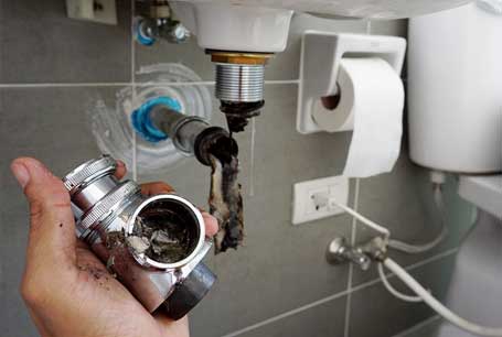 Worker Repairs the Bathroom Sink — Boca Raton, FL — Boca Certified Plumbing Worker Repairs the Bathroom Sink — Boca Raton, FL — Boca Certified Plumbing