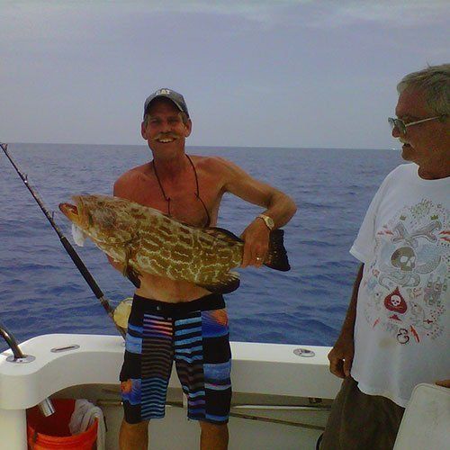Man  Holding a Brown Fish — Dania FL — Ironclad Welding
