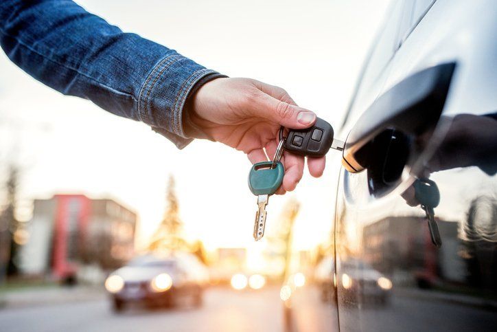 Man handing over keys to another man man handing over keys to another man