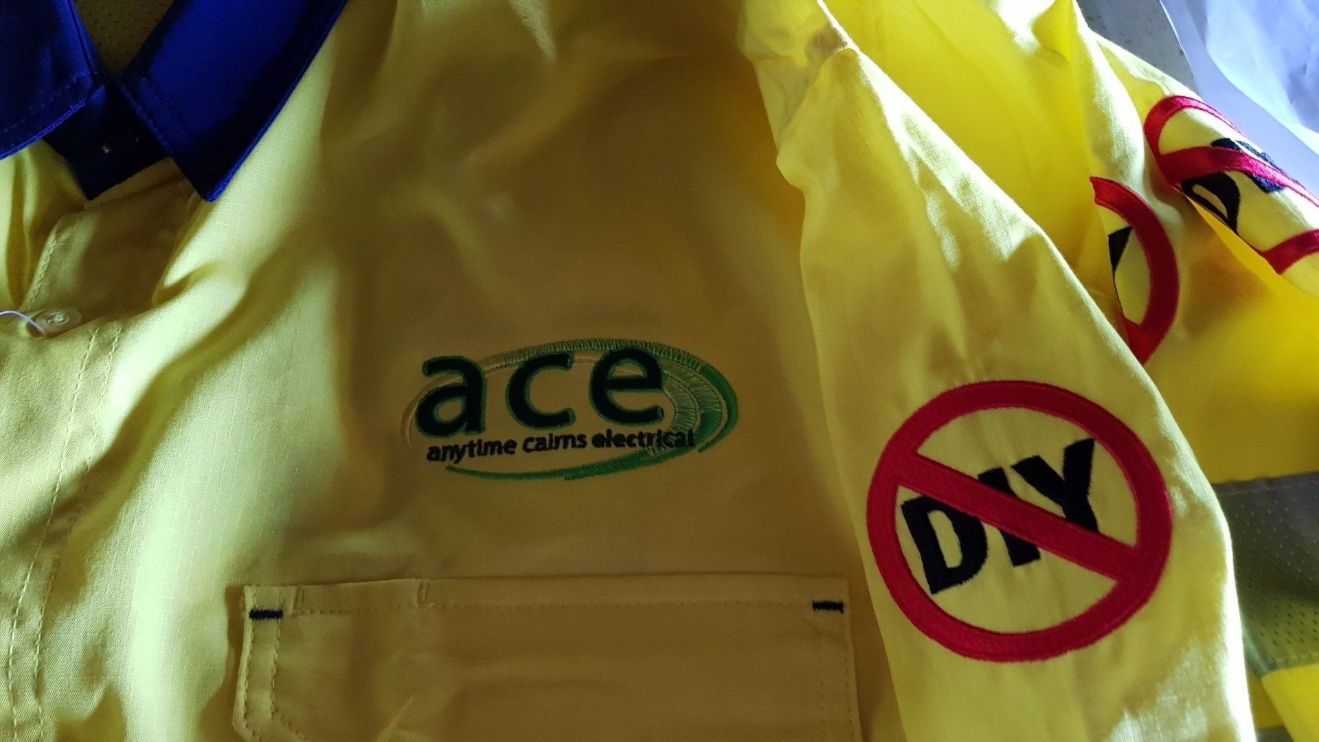Ace Logo on Uniform — Anytime Cairns Electrical in Cairns, QLD