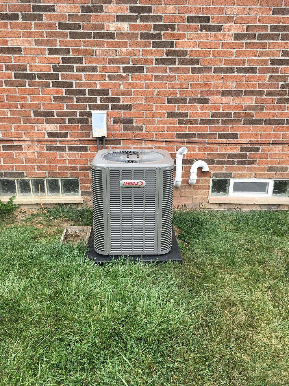 Heating System Beside House — Plymouth, MI — Keeth Heating and Air Conditioning