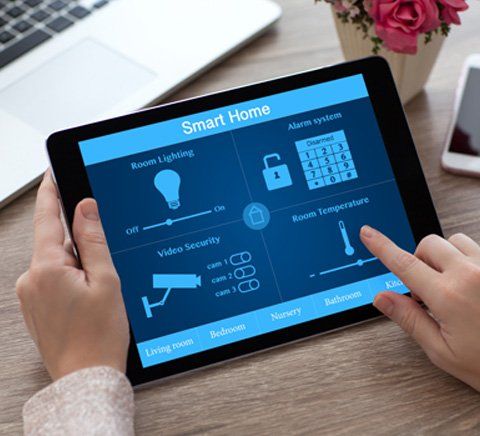 Alarms — A Person Using A Smart Home Tablet In Merrillville, IN Alarms — A Person Using A Smart Home Tablet In Merrillville, IN