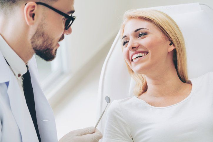 dentist talking with woman patient
